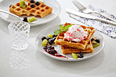 Waffles with blueberries, kiwi and black currant jam