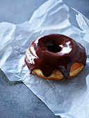 Chocolate donut on parchment paper