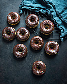 Vegan doughnuts with a cocoa and coconut glaze and colourful sugar sprinkles