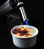 A crème brûlée being caramelised