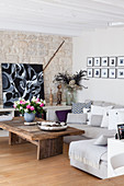 Rustic coffee table in living room with stone wall