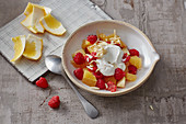 Fruit salad with a quark topping and almonds