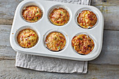 Egg muffins with peppers, tomatoes, cheese and ham