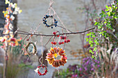 Mobile with wreaths of leaves, sloes, rose hips, crab apples and grass