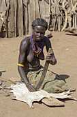 Daasanach woman curing skin