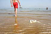 Bathers and salt, Dead Sea, Israel