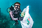 Scuba diver collecting plastic waste