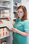 Pharmacy technician checking medication stocks