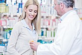 Pharmacist and customer in pharmacy