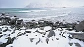Snow covered rocks on shore, Norway