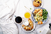 Scrambled eggs with cheese croissants, raspberry muffin and black coffee