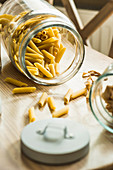 Raw penne pasta in jar