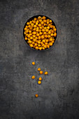 A bowl of chickpeas roasted in turmeric as a healthy snack (seen from above)
