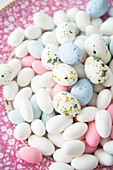 Speckled and plain sugar eggs on plate