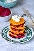 Carrot and beet patties stacked with ricotta