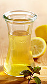 Homemade peppermint and lemon vinegar in a glass bottle