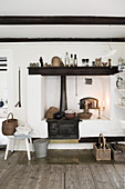 Old wood-fired kitchen cooker in rustic country-house kitchen