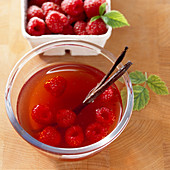 Homemade raspberry vinegar with vanilla and fresh berries