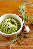 Homemade green herb salt with fresh rosemary, sage and garlic