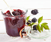 Sweet and sour blackberry ketchup with spices in a mason jar