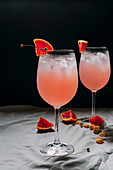 Cocktail grapefruit, alcoholic beverage with tropical fruits lavender and ice flowers