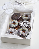 Doughnuts with chocolate glaze and sugar sprinkles as a gift