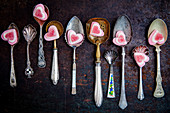 Various vintage spoons with vanilla hearts