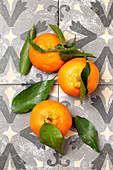 Three fresh mandarins with leaves