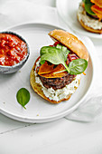 Burgers with grilled beef patties, cream cheese and spinach on classical bun