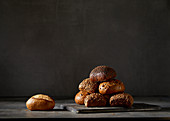 Various bread rolls in front of a dark background