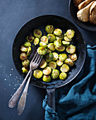 Oven-baked brussels sprouts with salt flakes and cress, and baguette slices