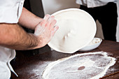 Preparing Pizza - Flatten and shape the dough