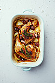 Oven-roasted chicken legs with olives, onions, garlic and thyme