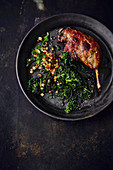 Roast duck leg with black cabbage and fried potatoes