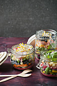 Layered salad with ham, blueberries and beetroot dressing