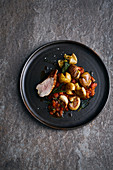 Roasted pork fillet with small potatoes and tomato sugo