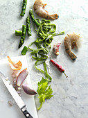 Green tagliatelle with vegetables and prawns being made