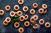 Linzer Augen (nutty shortcrust jam sandwich biscuits with holes on top for Christmas)