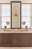 Luxurious bathroom with marble elements and symmetrical fittings