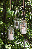 DIY candle lanterns hung from tree