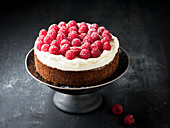 Nut cake with cream and raspberries