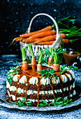 Carrot cake with salted caramel, garnished with fresh, fresh organic carrots