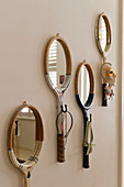 Mirrors with frames made from old tennis rackets and hook on wall