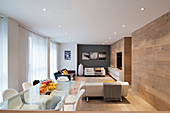 Oak panelling and designer furniture in spacious living room