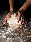 A man kneading bread dough