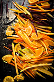 Strips of various carrots and purple carrots on a baking tray