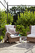 Wicker armchairs on country house terrace