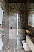 Shower area in the bathroom with mosaic tiles