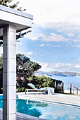 View of pool and lounger, in the background the sea