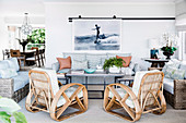 Designer rattan armchairs and sofas around a table in an open living room